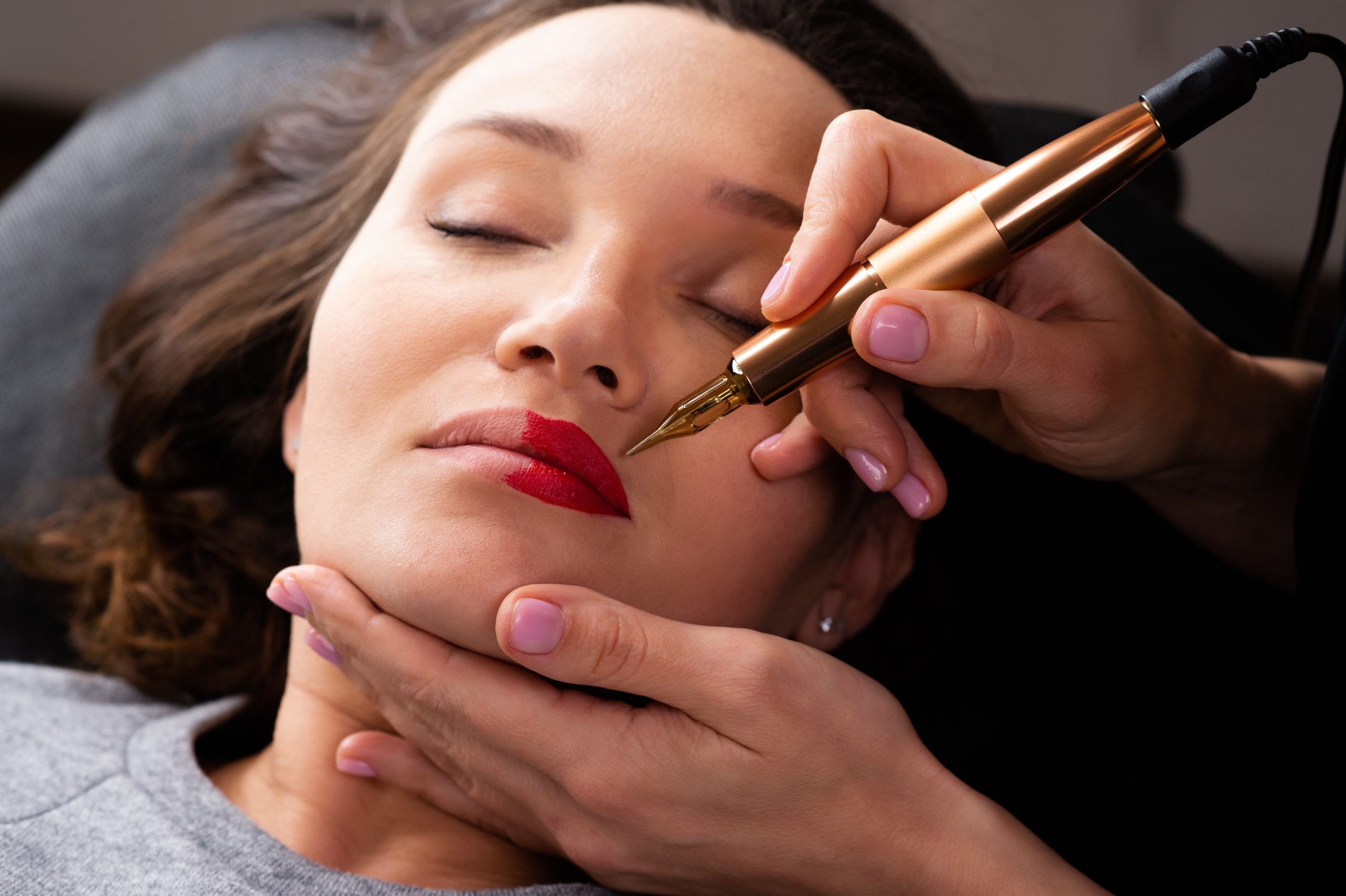 Customer getting lip color tattoo